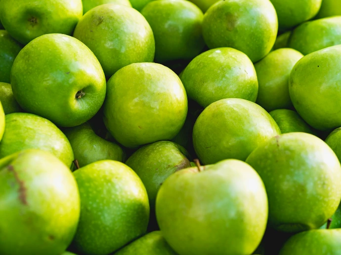 green apple fruit on brown wooden table